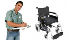 Man inspecting a power wheelchair clipboard.